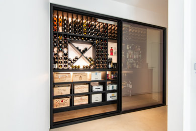 Example of a trendy wine cellar design in Sussex