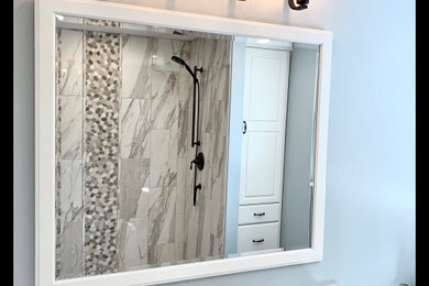 Transitional brown floor and single-sink bathroom photo in Boston with white cabinets and an undermount sink