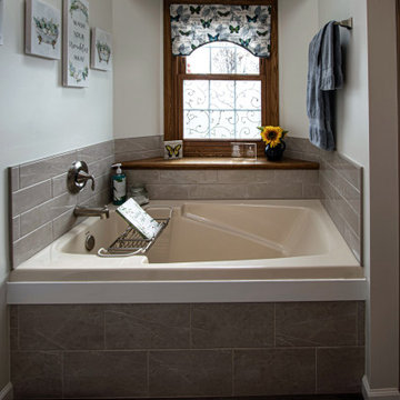 Waypoint Gray Shaker Door Cabinetry with Tiled Shower and Matching Tub Surround