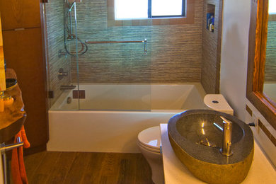 Example of a mid-sized trendy multicolored tile and mosaic tile porcelain tile bathroom design in Los Angeles with flat-panel cabinets, medium tone wood cabinets, white walls, a vessel sink and quartzite countertops