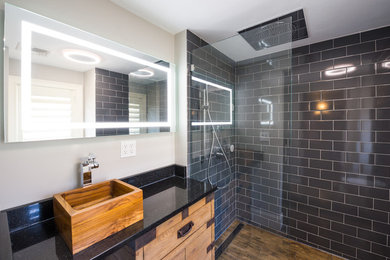 Design ideas for a mid-sized modern master bathroom in Boston with furniture-like cabinets, an alcove shower, a two-piece toilet, gray tile, ceramic tile, ceramic floors, granite benchtops, medium wood cabinets, white walls, a vessel sink, beige floor and an open shower.