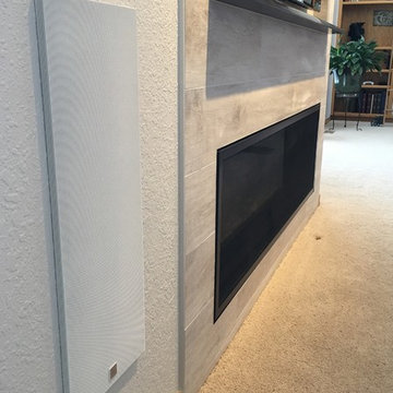 Linear fireplace, tile surround, granite mantle, & in-wall subwoofer