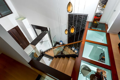 Large trendy wooden floating open staircase photo in Columbus