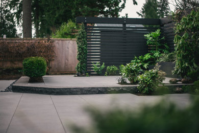 Photo of a modern partial sun backyard landscaping in Vancouver.