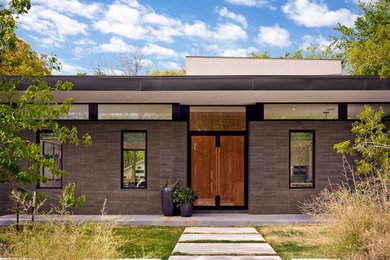 Minimalist gray one-story flat roof photo in Austin