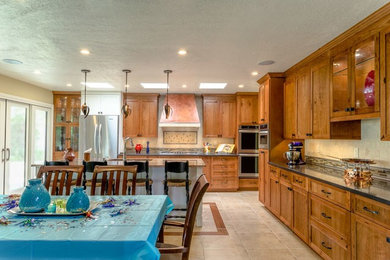 Example of a mid-sized classic ceramic tile kitchen/dining room combo design in Orange County with no fireplace