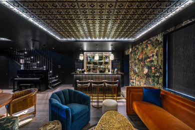 Inspiration for an eclectic galley home bar in London with dark hardwood flooring, brown floors and black worktops.