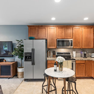 This is an example of a medium sized classic walk-out basement in Seattle with grey walls, concrete flooring, a hanging fireplace, a metal fireplace surround and blue floors.