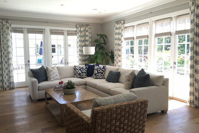 Living room - large coastal formal and enclosed light wood floor and brown floor living room idea in Los Angeles with gray walls