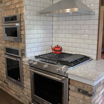 Atkinson, IL- Ranch Home Remodel With Bright White Cabinets and Brick Wall