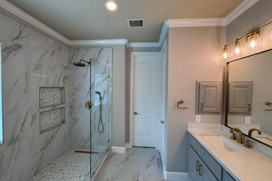 Large trendy porcelain tile porcelain tile and double-sink doorless shower photo in Houston with raised-panel cabinets, gray cabinets, beige walls, quartz countertops, white countertops, a niche and a built-in vanity