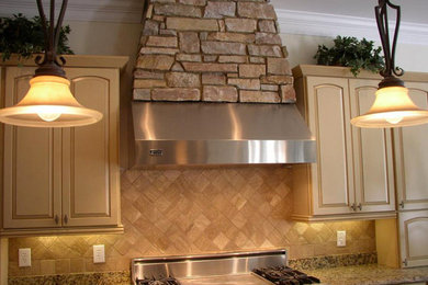 Example of a medium tone wood floor kitchen design in Raleigh with a drop-in sink, raised-panel cabinets, light wood cabinets, granite countertops, beige backsplash, stone tile backsplash and white appliances