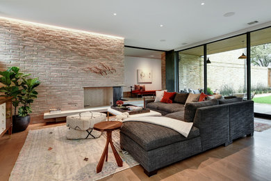 Transitional family room in Austin with a brick fireplace surround.