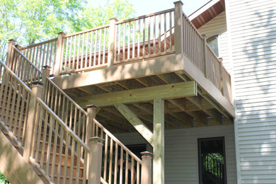 Large elegant backyard second story wood railing deck photo in Other with no cover