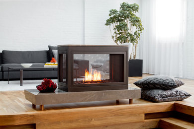 Living room - large contemporary formal and open concept medium tone wood floor living room idea in New York with white walls and a two-sided fireplace
