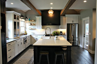 Inspiration for a mid-sized country l-shaped medium tone wood floor and brown floor eat-in kitchen remodel in Other with a farmhouse sink, shaker cabinets, white cabinets, quartz countertops, white backsplash, subway tile backsplash and stainless steel appliances
