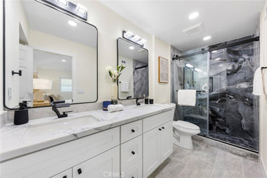Bathroom - mid-sized modern 3/4 black tile and porcelain tile porcelain tile, gray floor, double-sink and wall paneling bathroom idea in Orange County with shaker cabinets, white cabinets, a two-piece toilet, white walls, an undermount sink, quartz countertops, white countertops and a built-in vanity