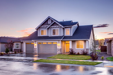 Large elegant gray two-story vinyl exterior home photo in Other with a shingle roof