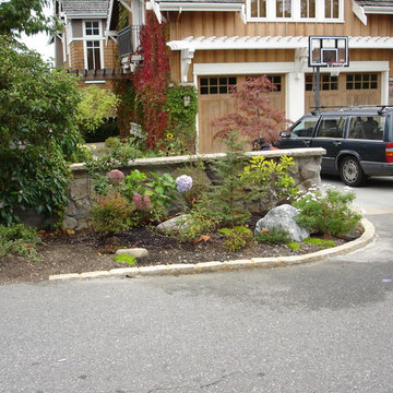 Driveway edger in cobblestone, wall in faux stone.