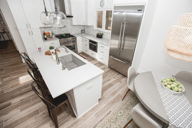 Small eat-in kitchen photo in Austin with an undermount sink, white cabinets, quartz countertops, white backsplash, an island and white countertops