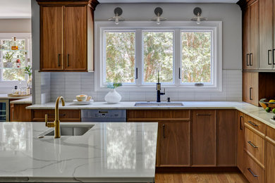 Open concept kitchen - large transitional l-shaped light wood floor and brown floor open concept kitchen idea in Chicago with an undermount sink, flat-panel cabinets, light wood cabinets, quartz countertops, white backsplash, porcelain backsplash, stainless steel appliances, an island and white countertops