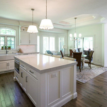 White Kitchen with Gray Quartz Countertops, Farmhouse Sink and Hardwood Floors