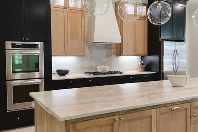 Example of a large transitional galley porcelain tile and beige floor eat-in kitchen design in New Orleans with an undermount sink, shaker cabinets, black cabinets, quartzite countertops, beige backsplash, stone slab backsplash, stainless steel appliances, an island and beige countertops