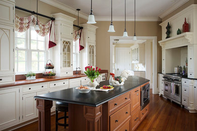 Large elegant medium tone wood floor kitchen photo in Boston with beaded inset cabinets, white cabinets and an island