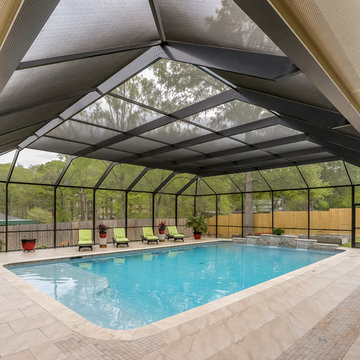 Patio with Fireplace with Screened Pool Enclosure
