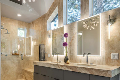 Bathroom - contemporary master beige tile and marble tile vinyl floor, double-sink and vaulted ceiling bathroom idea in Portland with flat-panel cabinets, gray cabinets, beige walls, an undermount sink, marble countertops, a hinged shower door, beige countertops and a floating vanity