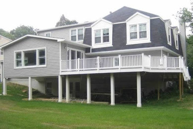 Example of a large classic gray split-level wood gable roof design in DC Metro