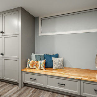 Photo of a small traditional look-out basement in Ottawa with blue walls, laminate floors, no fireplace and grey floors.