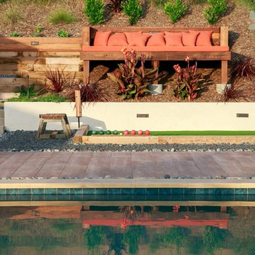 Backyard Pool Flanked by Bocce Court and Built-In Bench