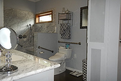 Inspiration for a large modern master cork floor bathroom remodel in New Orleans with an undermount sink, open cabinets, gray cabinets, marble countertops, a bidet and gray walls