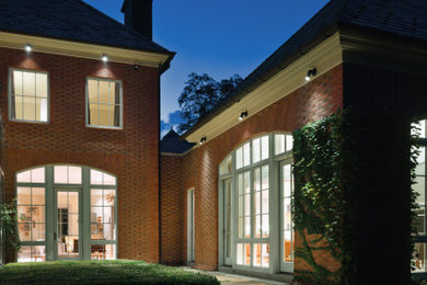Inspiration for a huge transitional courtyard brick patio remodel in Other with no cover
