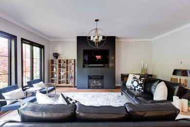 Large transitional open concept medium tone wood floor and brown floor living room photo in Other with a standard fireplace, a stone fireplace and a wall-mounted tv