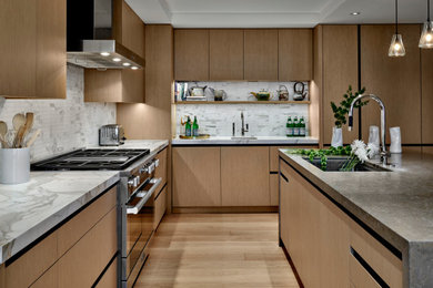 Inspiration for a contemporary l-shaped light wood floor and tray ceiling open concept kitchen remodel in Chicago with a single-bowl sink, flat-panel cabinets, light wood cabinets, marble countertops, white backsplash, marble backsplash, paneled appliances, a peninsula and white countertops
