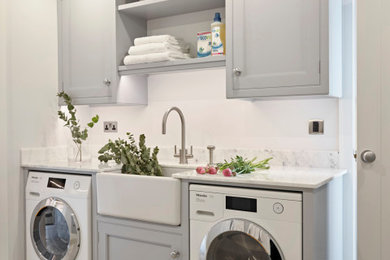 Small contemporary single-wall dedicated laundry room in Other with a farmhouse sink, beaded inset cabinets, grey cabinets, marble benchtops, grey walls and white benchtop.