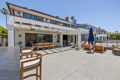 Inspiration for a large coastal white two-story board and batten house exterior remodel in Los Angeles