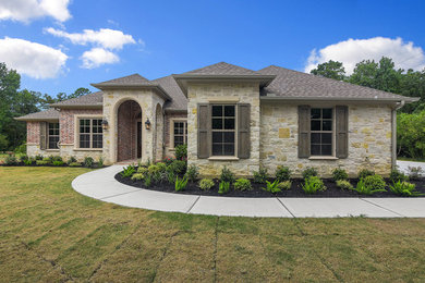 Large transitional gray one-story brick exterior home idea in Houston with a hip roof