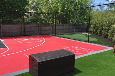 Photo of a large traditional backyard outdoor basketball/tennis/multi-game court in Boston.