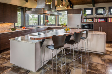 Large trendy l-shaped open concept kitchen photo in Denver with a drop-in sink, flat-panel cabinets, dark wood cabinets, marble countertops, beige backsplash, stainless steel appliances, an island and stone slab backsplash