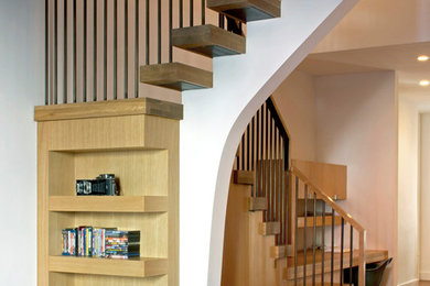Staircase - mid-sized modern wooden u-shaped mixed material railing staircase idea in New York with wooden risers