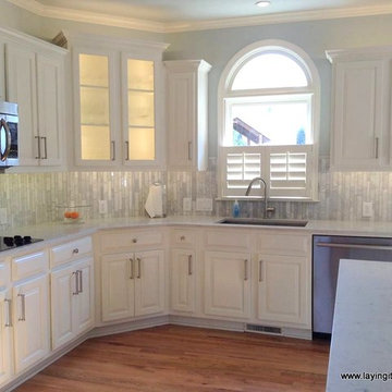 Linear Carrara on a vertical lay complimenting a Quartz counter top