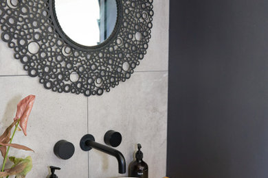 Design ideas for a small country powder room with light wood cabinets, a one-piece toilet, gray tile, ceramic tile, grey walls, ceramic floors, a vessel sink, grey floor and a built-in vanity.