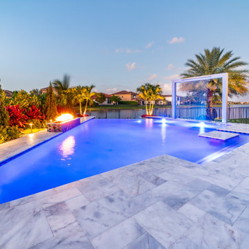 Beautiful Custom Pool with Fire Feature and Pergola