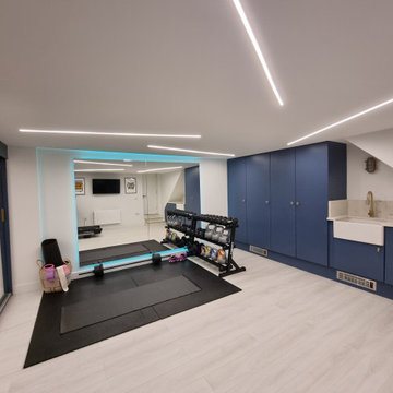 Home gym with integrated utilities room