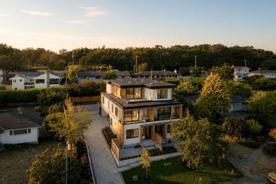 Inspiration for a huge contemporary four-story exterior home remodel in Other with a brown roof