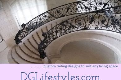Large trendy metal curved metal railing and brick wall staircase photo in Miami with marble risers