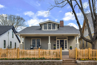 Traditional green house exterior idea in Nashville with a gray roof